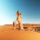 woman in brown pants standing on desert